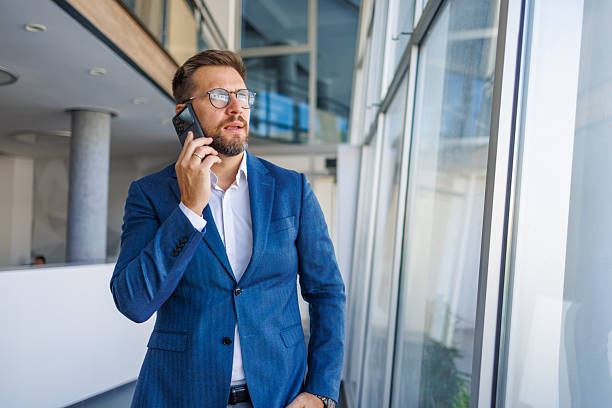 istock Businessman talking on phone in modern office building 2232751787
