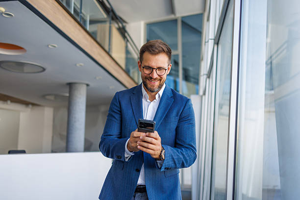 istock Happy businessman using mobile phone in office 2232751876