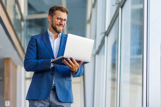 istock Businessman working on laptop in modern office building 2232752016