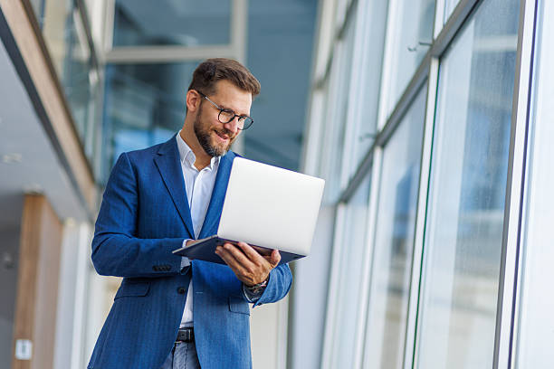 istock Businessman working on laptop in modern office building 2232752017