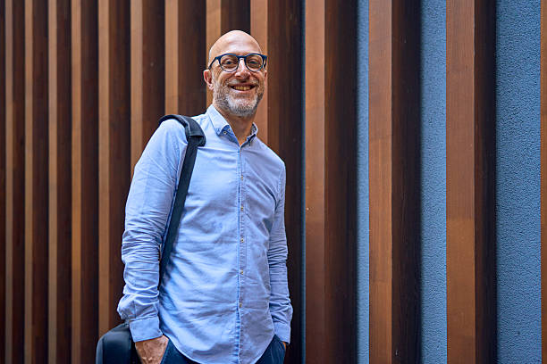 istock Smiling businessman posing in front of a modern building 2232754357