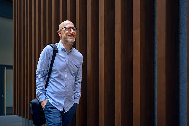 Smiling businessman walking in modern office building