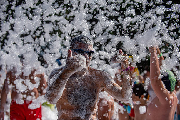 istock A man calling other people at a foam party 2232754781