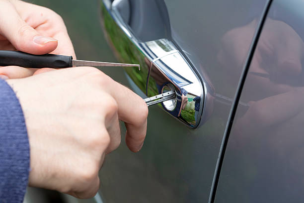 istock The hijacker tries to break into the car with a scanner. Code grabber . Car thief, car theft. 2232756210