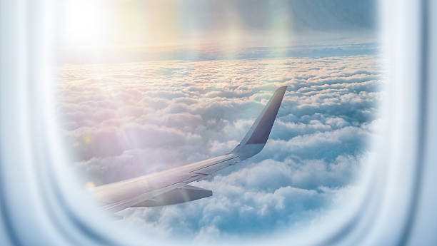 istock View from Airplane Window Above the Clouds at Sunset 2232760033