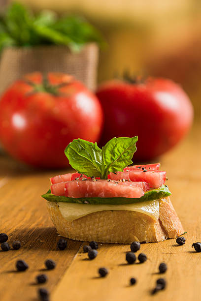 Table with bruschetta in the kitchen. Preparing vegan sandwich. Home made food concept. No people. High quality photo