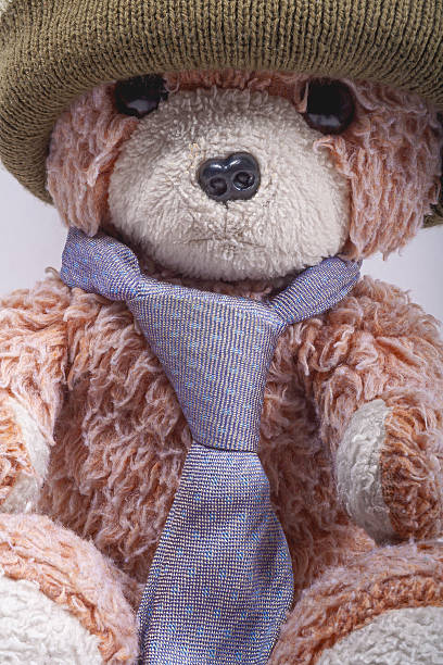 istock Close up of Old teddy bear with hat and tie 2232764400