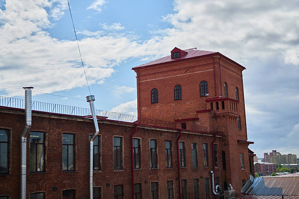 istock A historic red brick building featuring an impressive tower, all under a cloudy sky backdrop 2232764635
