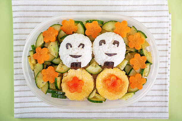 Bento box with onigiri with chicken filling and vegetables. toning