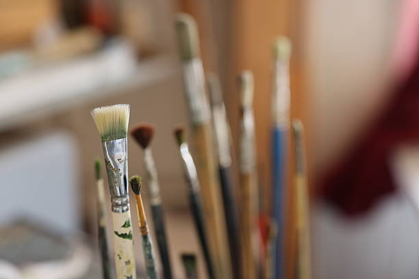 A captivating collection of various paintbrushes showcasing immense artistry and creativity in a vibrant workspace