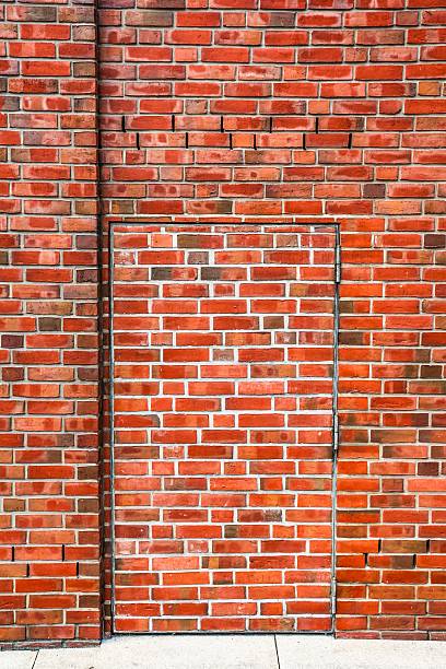 istock Secret door blending with red brick wall 2232773376