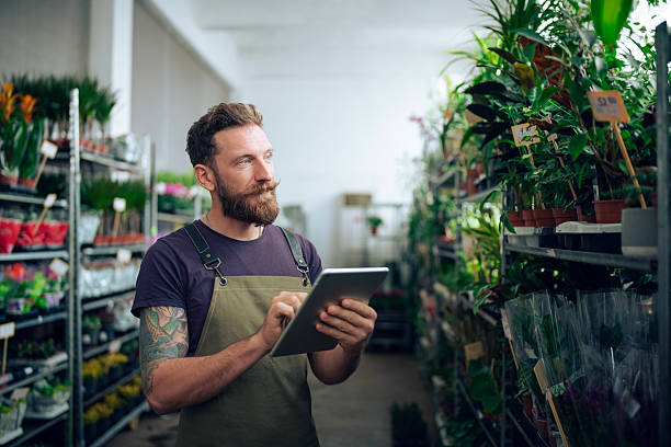 istock Bearded man using digital tablet and working in Flower store. 2232775328