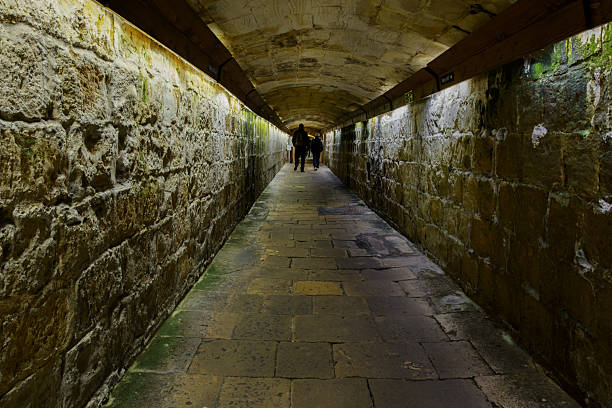 Valletta, Malta - March 3, 2025: Limestone tunnel with arched ceiling and illuminated walls forming part of the historic fortifications in Valletta, Malta