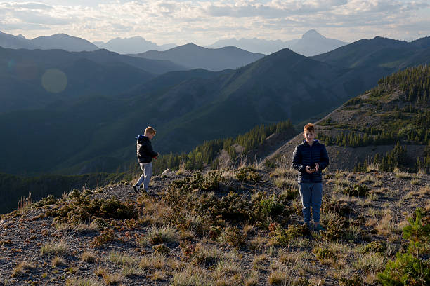 istock Young brothers pick wild raspberries on mountain ridge 2232776029