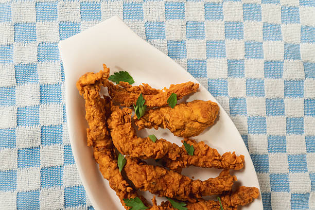 istock Close-up view of fried chicken on a checkered tablecloth. 2232777198