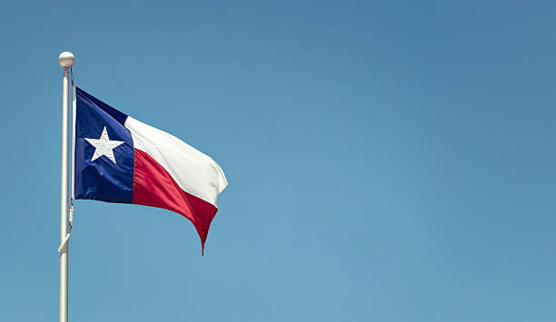istock Texas State flag waving in the wing against blue sky 2232777304