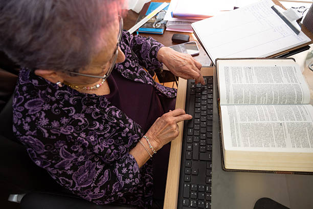 istock Senior counselor using Bible and computer for therapy planning 2232781514
