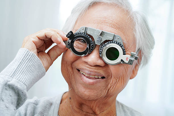 istock Asian senior woman wearing ophthalmic vision eye test and using optical trial frame. 2232783717