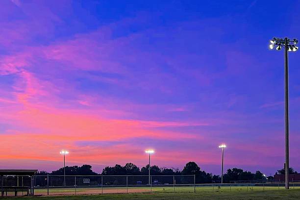 istock Blue and orange sunset over baseball field 2232786549