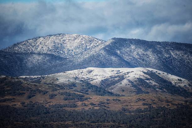 istock The snow dusted Brindabella Mountain Range, looking over the Tuggeranong valley. Canberra, Australia. Winter. Snow. Suburbia. 2232788384