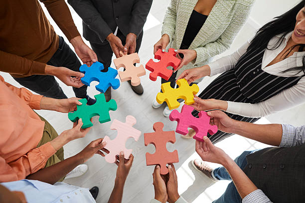 istock Diverse employees connect jigsaw puzzle pieces 2232790680