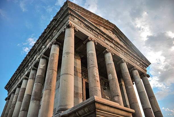 Garni, Armenia - July 29, 2012 - Ancient temple with corinthian columns against blue sky and cloudy background.