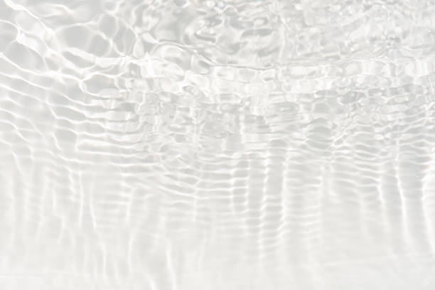 istock White water with ripples on the surface. Defocus blurred transparent white colored clear calm water surface texture with splashes and bubbles. Water waves with shining pattern texture background. 2232795027