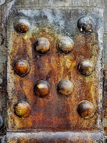 Large size bolts and nuts in iron and steel factories, old vintage rusty metal door