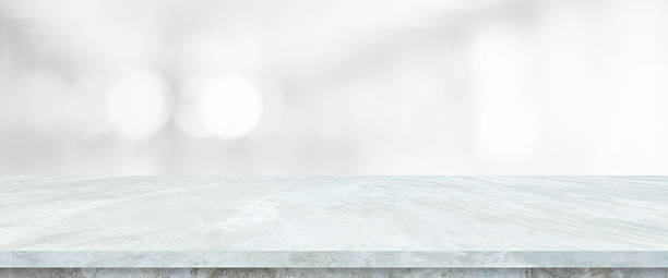 istock Empty white table top, counter, desk background over blur abstract bokeh light background, White marble stone table, shelf and blurred white background for food, product display mockup, template 2232797159