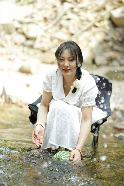 istock Playing in the water by the stream 2232798262