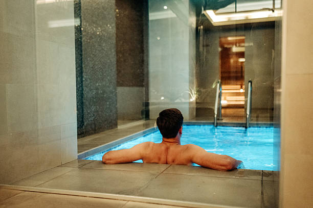 istock Young handsome man relaxing in a pool by himself 2232802515