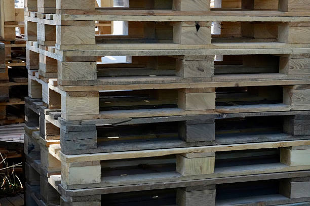 istock Wooden pallets stacked in a warehouse, ready for shipment. 2232805773