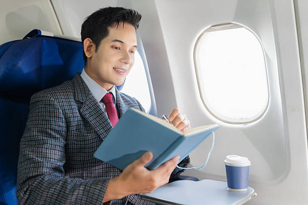 istock Businessman working and update with calendar, schedule, timetable, and management, event planning sitting in airplane. 2232806628