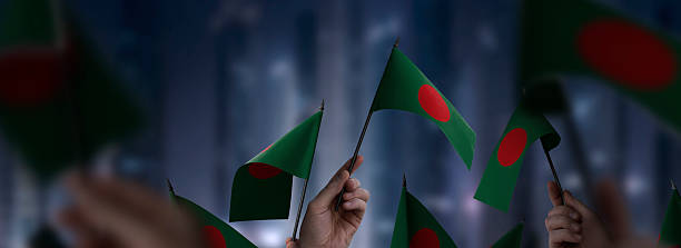 istock Bangladesh flags in their hands on a blurred urban background 2232807163