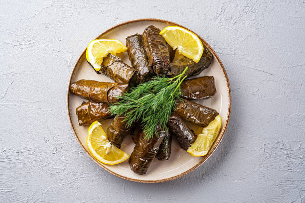 istock Delicious Turkish dish, stuffed grape leaves, on a stone table 2232807329