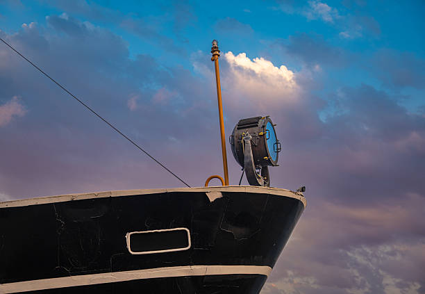 large searchlight on the bow of the old ship.