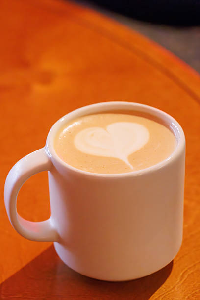 istock Warm cappuccino in a cup with heart-shaped latte art on top 2232808463