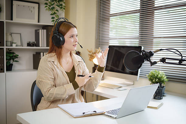 istock Podcast creator in headphones recording content with a professional microphone setup. 2232809436