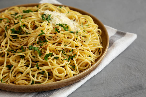 istock Homemade Italian Spaghetti Aglio e Olio on a Plate, side view. Copy space. 2232809585