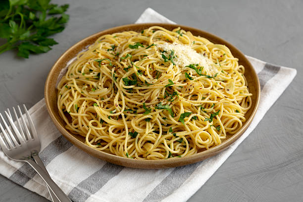 istock Homemade Italian Spaghetti Aglio e Olio on a Plate, side view. 2232809662