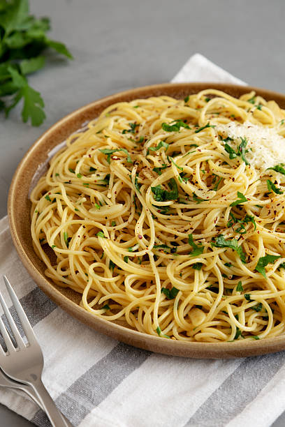 istock Homemade Italian Spaghetti Aglio e Olio on a Plate, side view. 2232809665