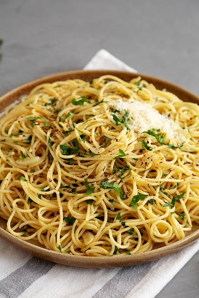 istock Homemade Italian Spaghetti Aglio e Olio on a Plate, side view. 2232809694