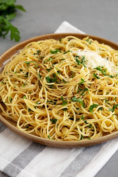 istock Homemade Italian Spaghetti Aglio e Olio on a Plate, side view. 2232809739