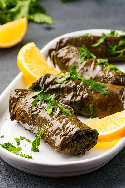istock Delicious Turkish dish, stuffed vine leaves, on a black stone table 2232814425