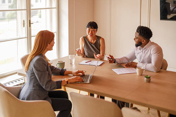 istock Professionals analyzing reports and collaborating on strategic solutions during meeting in board room 2232816402