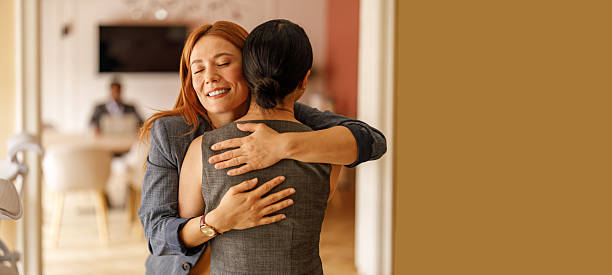 istock Confident female professional smiling and embracing colleague in office expressing support and encouragement 2232816462