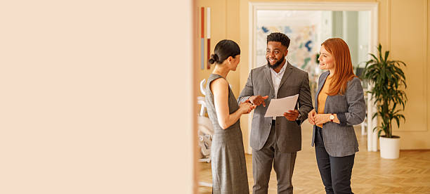 istock Male accountant analyzing financial documents with female coworkers during planning session in corporate office 2232816492