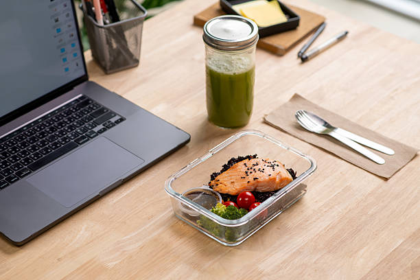 istock Salmon and Riceberry meal prep container on the office desk. 2232816537
