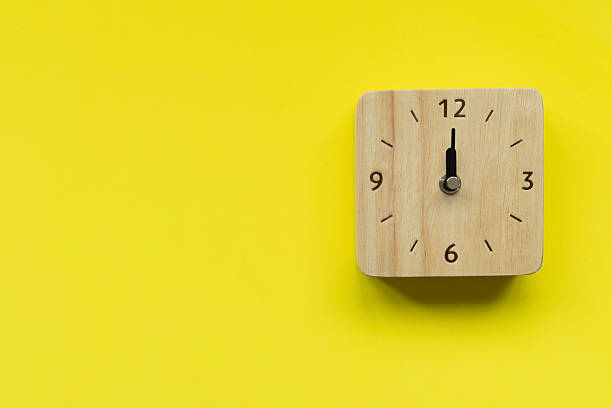 istock Retro alarm clock on yellow table background, vintage style, flat lay 2232816945