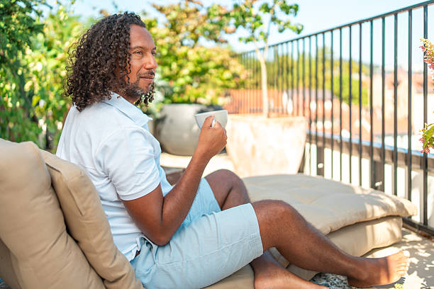 istock Hispanic Man Savoring Beverage on Scenic Building Terrace 2232817847